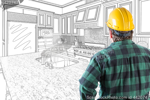 Image of Male Contractor with Hard Hat Looking At Custom Kitchen Drawing 