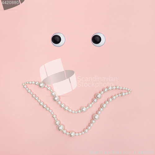 Image of Shiny pearl smile on pink background