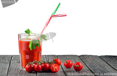 Image of Glass of tomato juice with cocktail stick