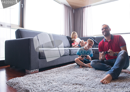 Image of Happy family playing a video game