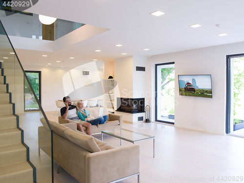 Image of young happy couple relaxes in the living room