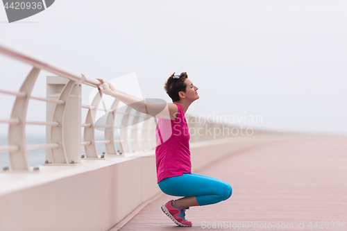 Image of woman stretching and warming up on the promenade