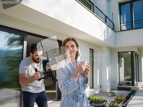 Image of woman in a bathrobe enjoying morning coffee