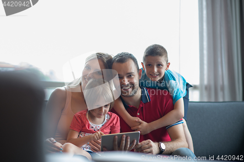 Image of happy young couple spending time with kids