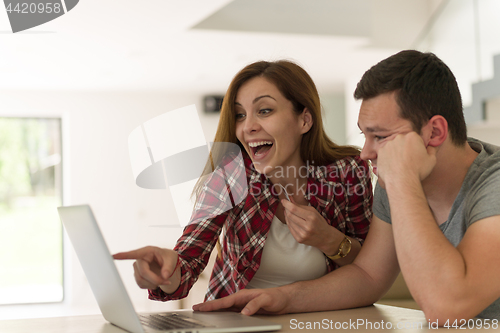 Image of happy young couple buying online