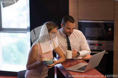 Image of A young couple is preparing for a job and using a laptop