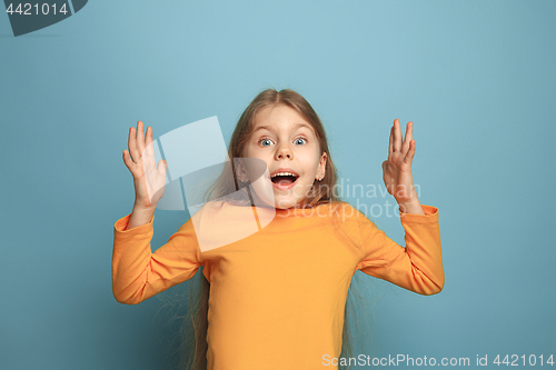 Image of The surprise, happiness, joy, victory, success and luck. Teen girl on a blue background. Facial expressions and people emotions concept