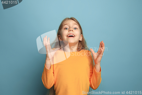 Image of The surprise, happiness, joy, victory, success and luck. Teen girl on a blue background. Facial expressions and people emotions concept