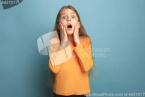 Image of The surprise, happiness, joy, victory, success and luck. Teen girl on a blue background. Facial expressions and people emotions concept