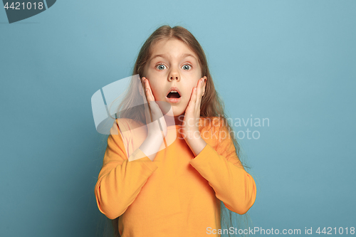Image of The surprise, happiness, joy, victory, success and luck. Teen girl on a blue background. Facial expressions and people emotions concept