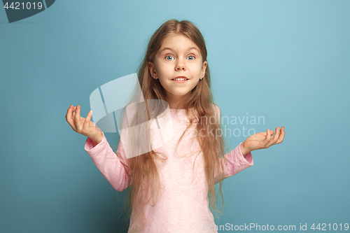 Image of The surprise, happiness, joy, victory, success and luck. Teen girl on a blue background. Facial expressions and people emotions concept