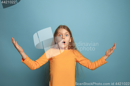 Image of The surprise, happiness, joy, victory, success and luck. Teen girl on a blue background. Facial expressions and people emotions concept