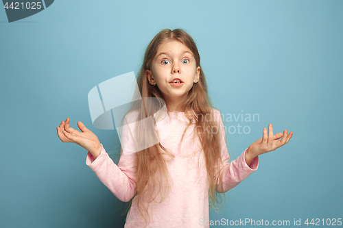 Image of The surprise, happiness, joy, victory, success and luck. Teen girl on a blue background. Facial expressions and people emotions concept
