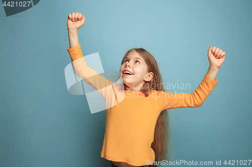 Image of Win - emotional blonde teen girl have a happiness look and toothy smiling. Studio shot