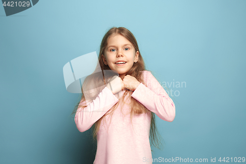 Image of Win - emotional blonde teen girl have a happiness look and toothy smiling. Studio shot