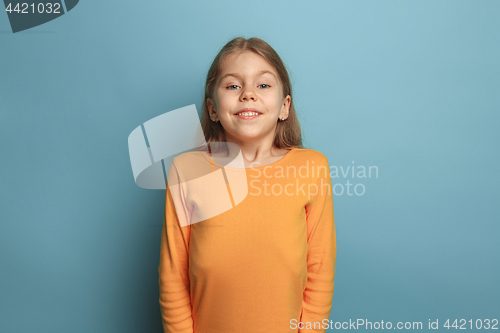 Image of The surprise, happiness, joy, victory, success and luck. Teen girl on a blue background. Facial expressions and people emotions concept