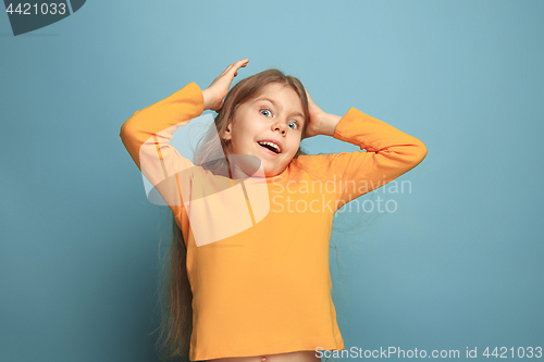 Image of Win - emotional blonde teen girl have a happiness look and toothy smiling. Studio shot