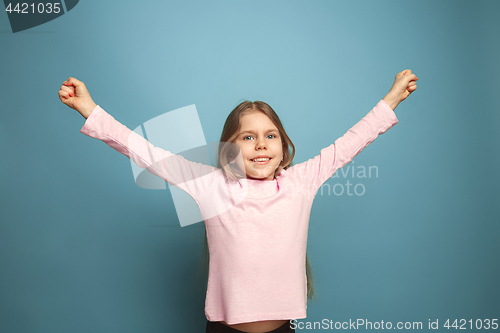 Image of Win - emotional blonde teen girl have a happiness look and toothy smiling. Studio shot