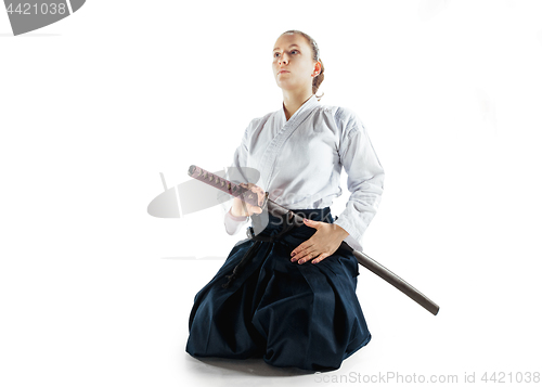 Image of Aikido master practices defense posture. Healthy lifestyle and sports concept. Woman in white kimono on white background.