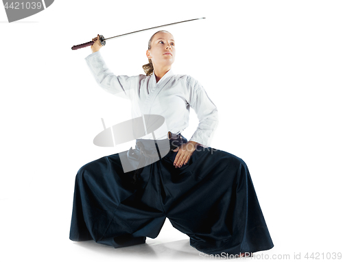 Image of Aikido master practices defense posture. Healthy lifestyle and sports concept. Woman in white kimono on white background.