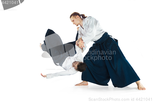 Image of Man and woman fighting at Aikido training in martial arts school