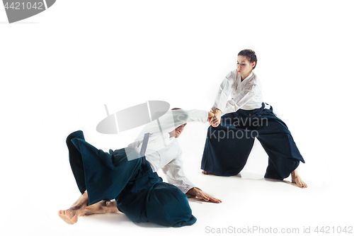 Image of Man and woman fighting at Aikido training in martial arts school