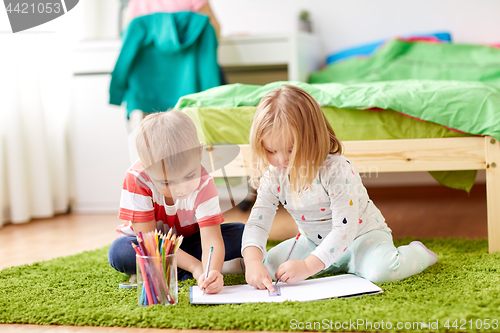 Image of happy kids drawing at home