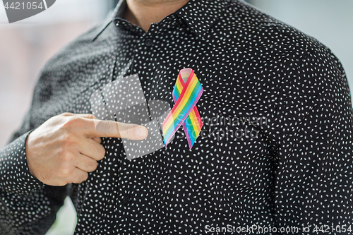 Image of man with gay pride rainbow awareness ribbon