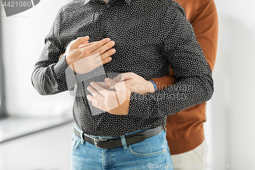 Image of close up of hugging male gay couple