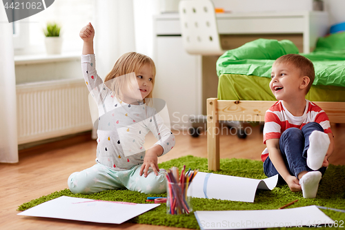 Image of happy kids drawing at home