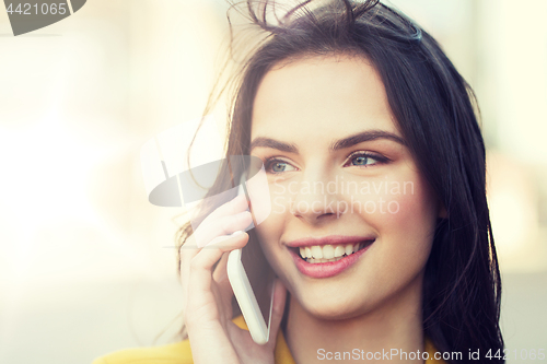 Image of smiling young woman or girl calling on smartphone