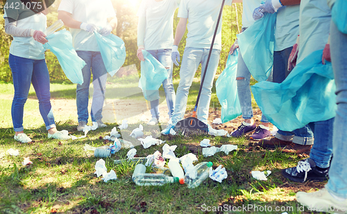 Image of volunteers with garbage bags cleaning park area