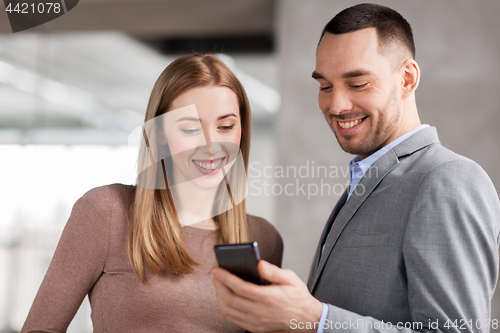 Image of businesswoman and businessman with smartphone