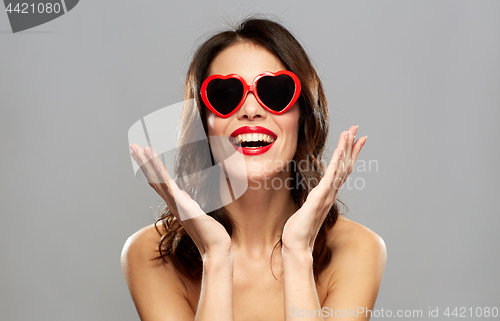 Image of woman with red lipstick and heart shaped shades