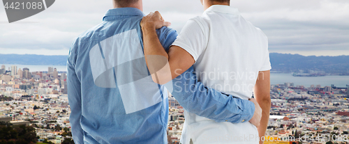 Image of close up of gay couple hugging over san francisco