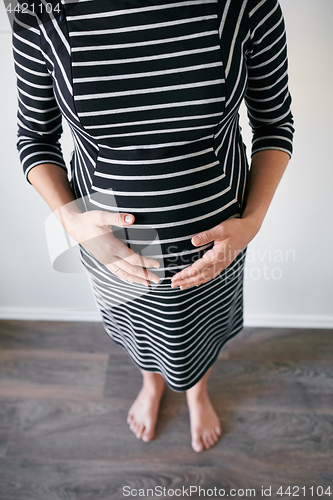 Image of Pregnant woman in striped dress