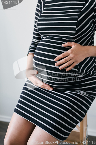 Image of Pregnant woman in striped dress