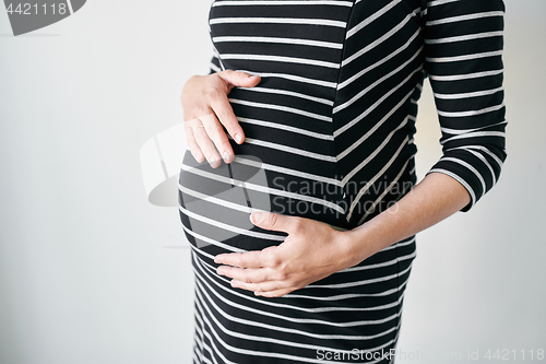 Image of Pregnant woman in striped dress