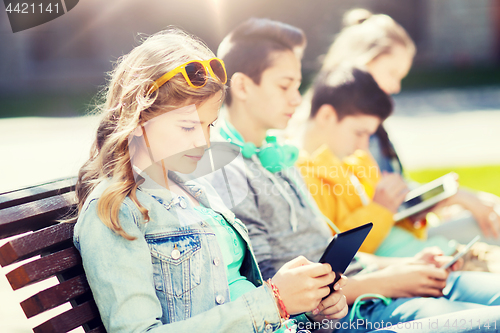 Image of happy friends with tablet pc computer outdoors