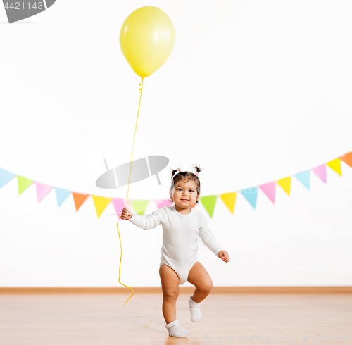 Image of happy baby girl with balloons on birthday party