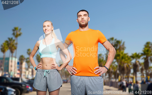 Image of couple doing sports at summer over venice beach