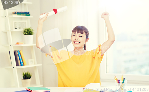 Image of happy asian woman student with diploma at home