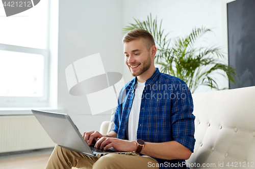 Image of man with laptop working at office