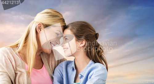 Image of happy smiling mother and daughter over sky