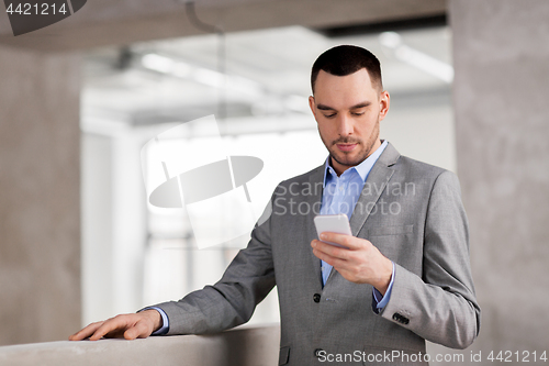 Image of businessman with smarphone at office