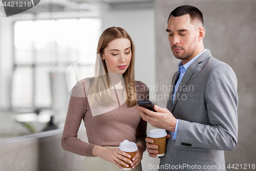 Image of businesswoman and businessman with smartphone