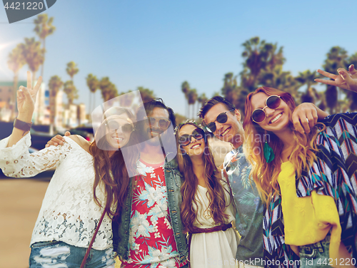 Image of hippie friends showing peace over venice beach 