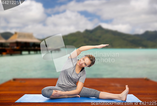 Image of happy woman making yoga and stretching outdoors