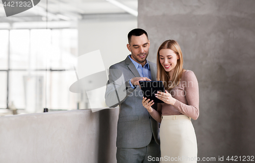 Image of businesswoman and businessman with tablet pc