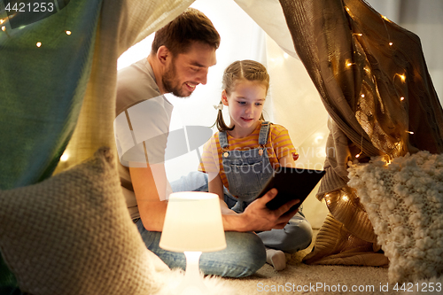 Image of family with tablet pc in kids tent at home